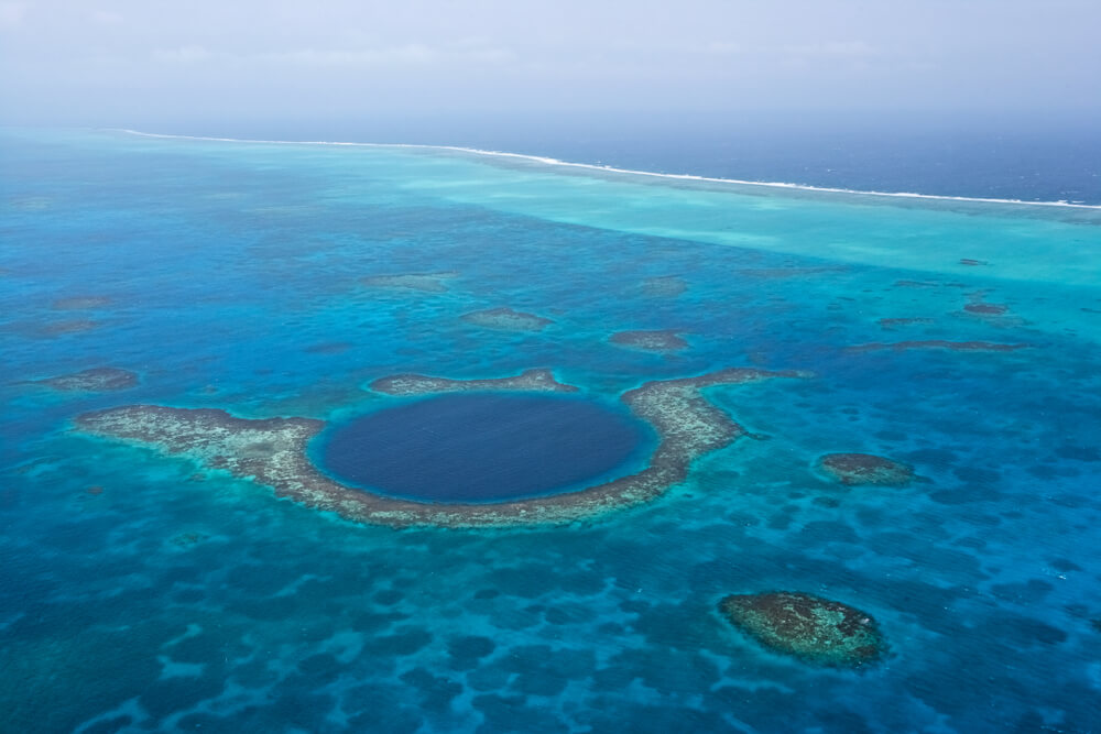Aerial view of coral reefs and the Blue Hole, Lighthouse Atoll, Belize