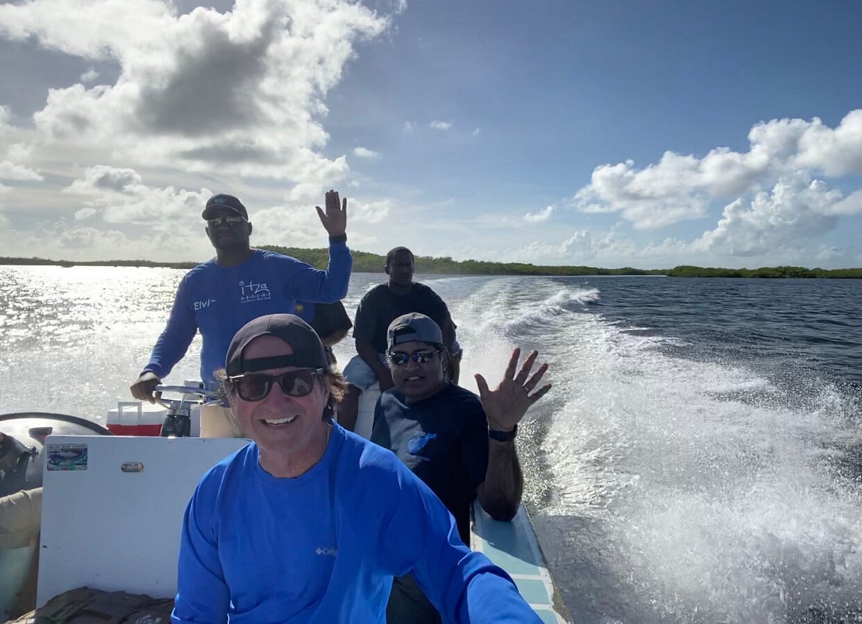 Elvis boat captain at Itza Resort navigating divers to Lighthouse Reef dive sites in Belize