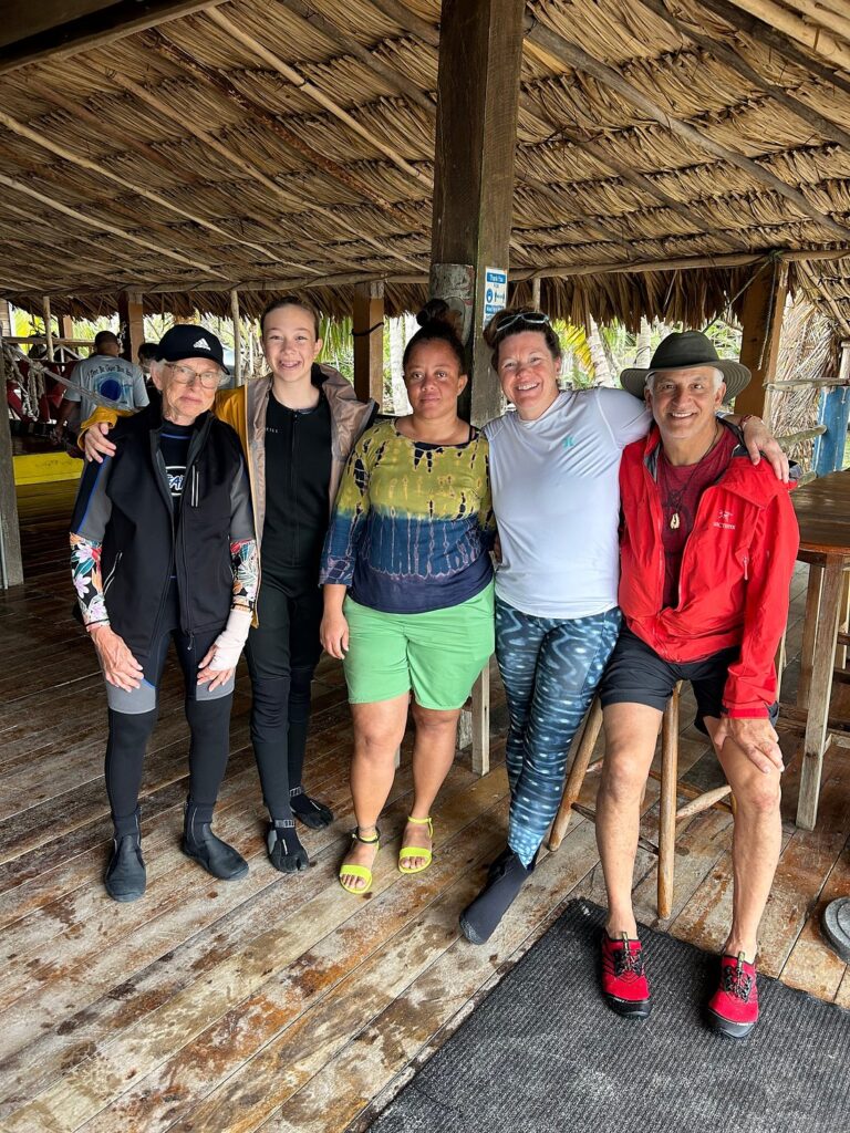 Group of guests with Itza Resort staff at Lighthouse Reef Atoll Belize showing personal service and small crew experience