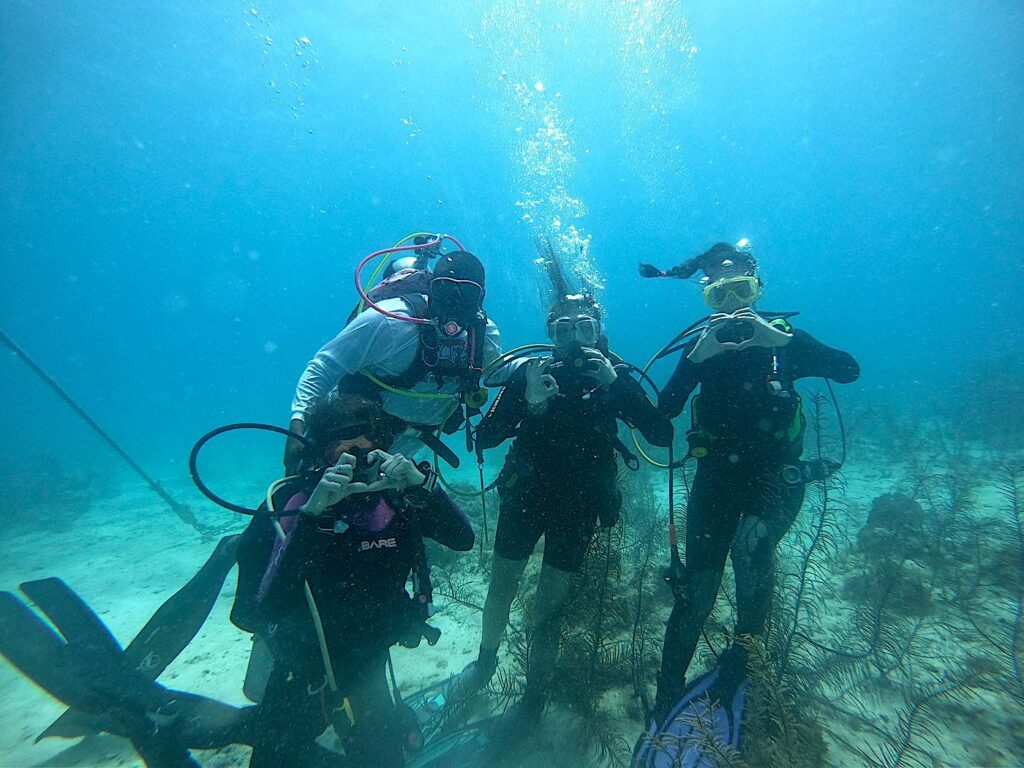 Scuba certification training with instructor at Itza Resort Belize showing real diving experience and cost factors like instruction, safety and guided dives