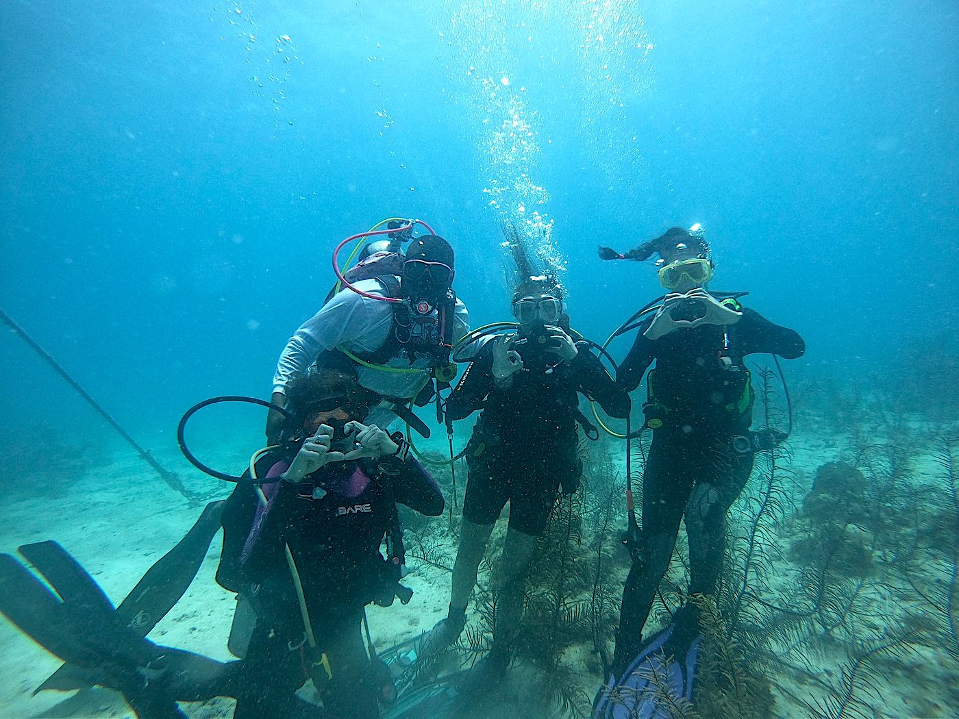 Scuba certification training with instructor at Itza Resort Belize showing real diving experience and cost factors like instruction, safety and guided dives