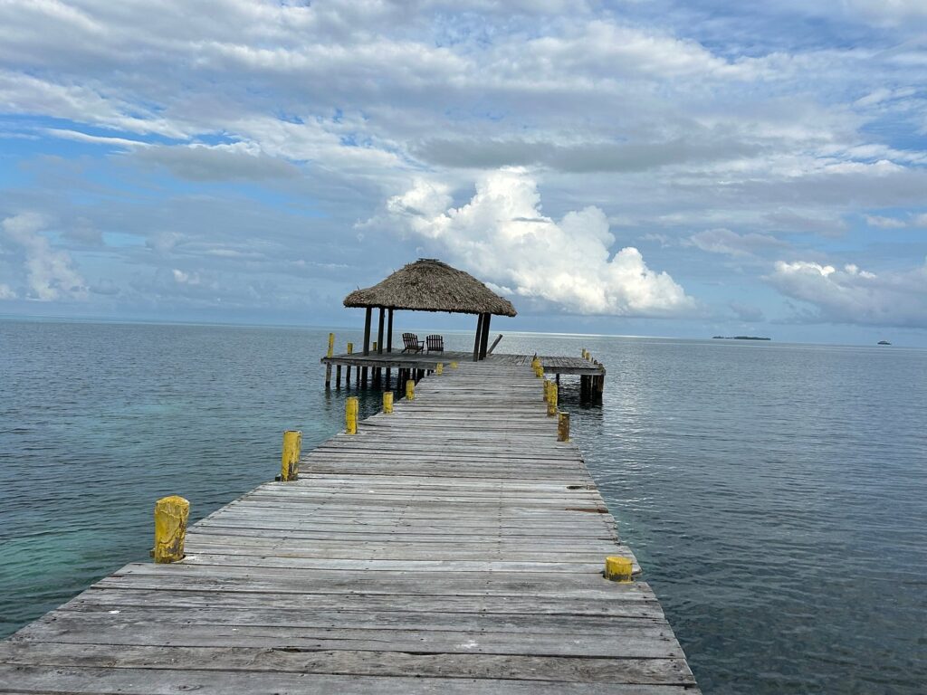 Wooden dock at Itza Resort Lighthouse Reef Belize overlooking calm Caribbean water