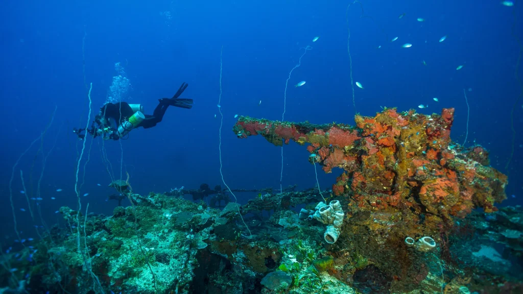 Diver exploring a WWII wreck in Truk Lagoon, one of the world’s most unforgettable wreck diving destinations